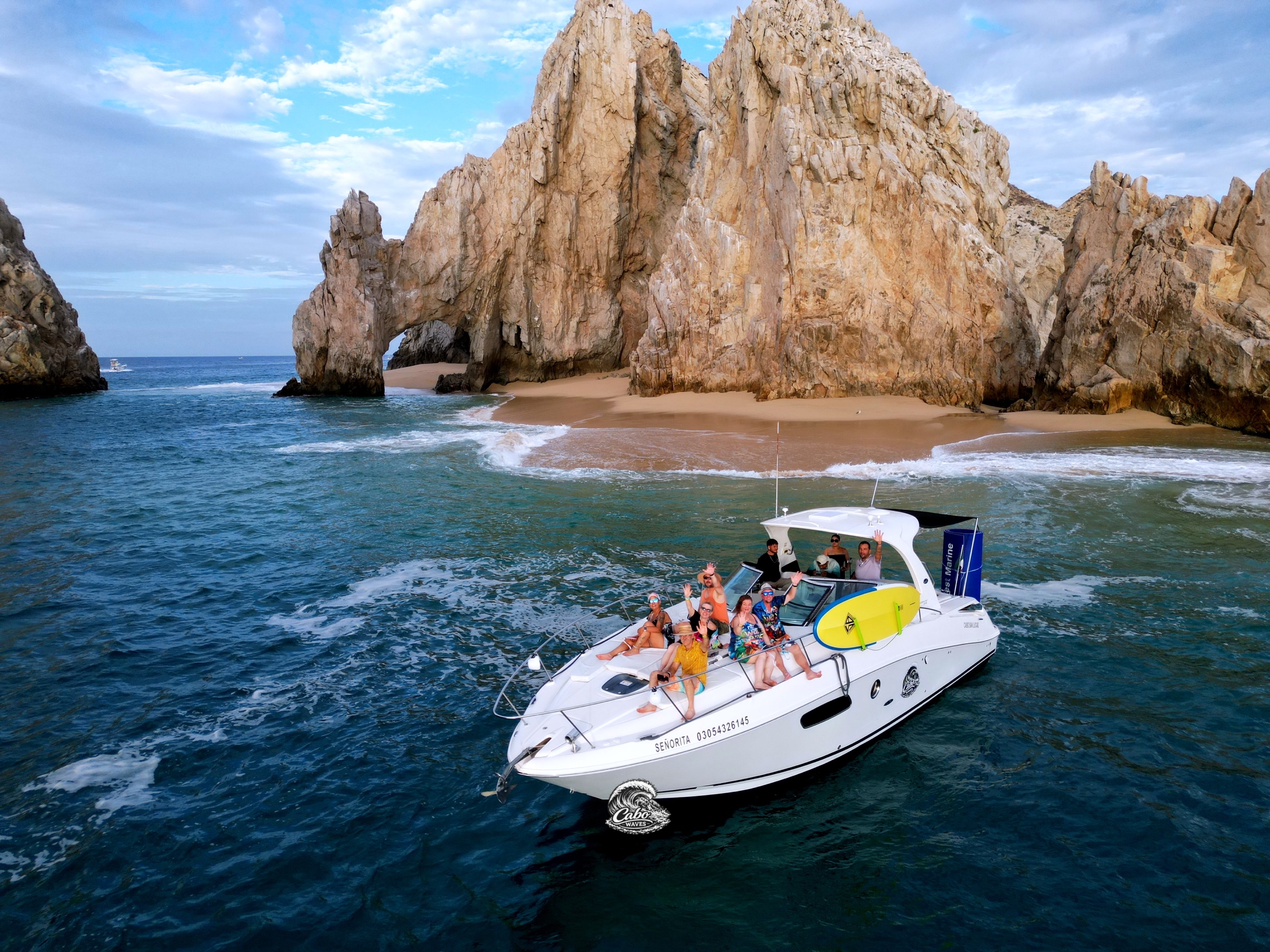 Guests waving from Señorita beside El Arco
