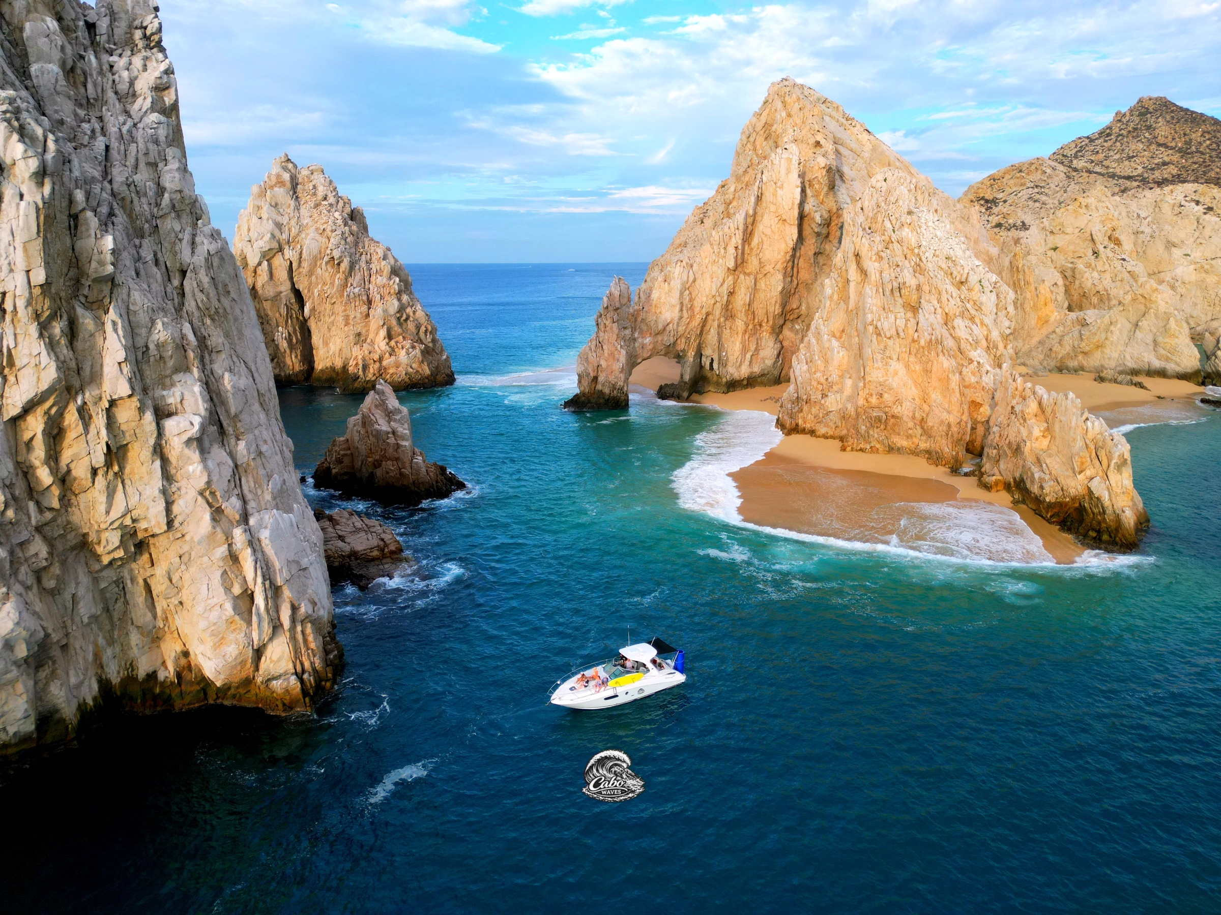 Señorita passing through the blue water beside El Arco