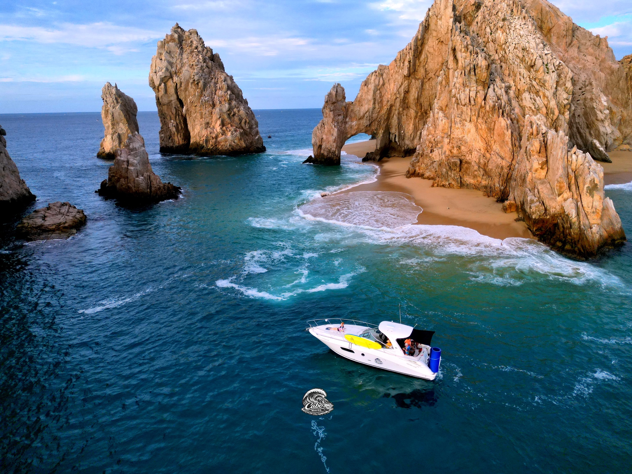 Señorita cruising below El Arco with a paddleboard secured on deck